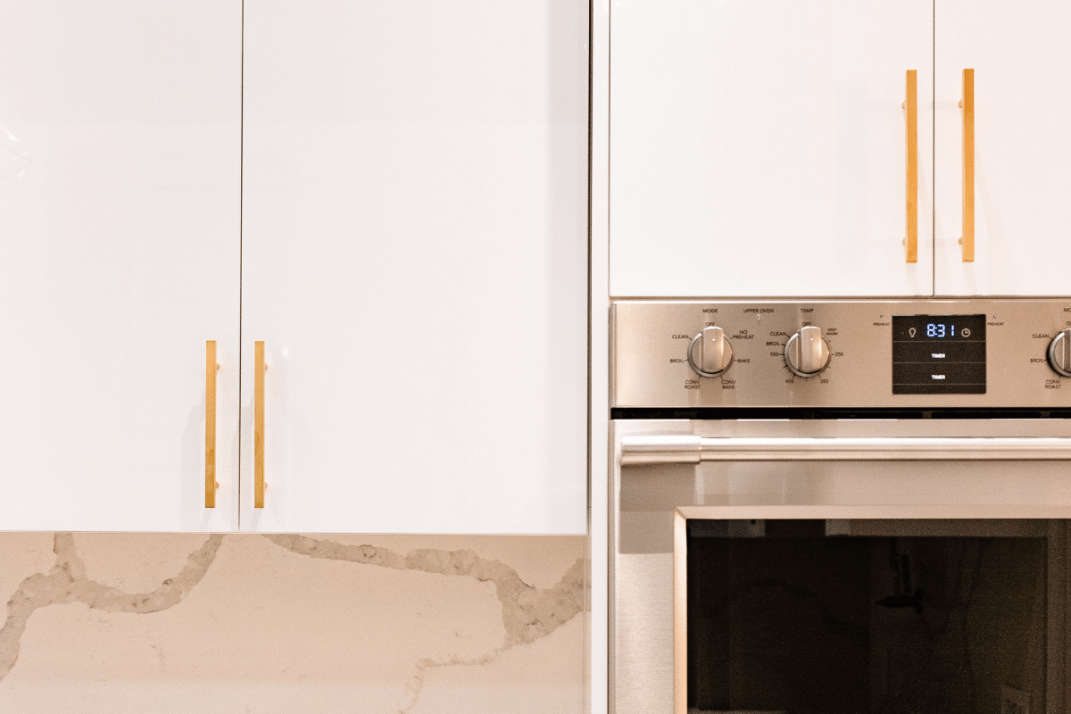 Slab cabinet doors with bold gold hardware
